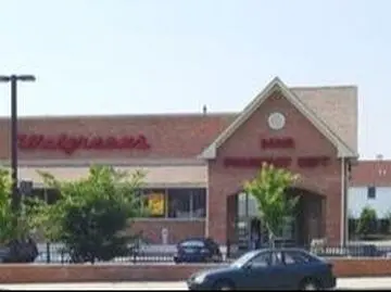 A large brick building with a car parked in front of it.