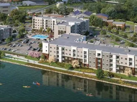 An aerial view of a building with water in the background.