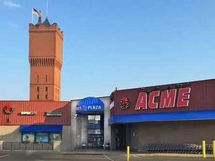 A large building with a tower in the background.